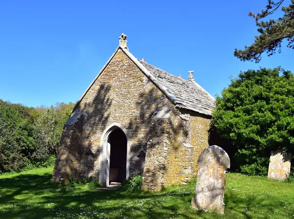 Small stone chancel of Fleet Old Church among gravestones at East Fleet, near Chickerell