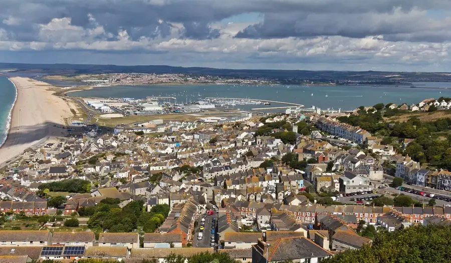 Rooftops of Fortuneswell with Chesil Beach and Portland Harbour beyond, Isle of Portland