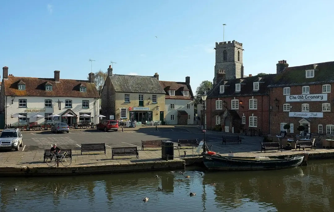 Historic buildings and rooftops around The Quay in Wareham with the church tower behind